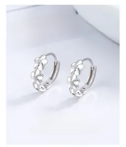 Close-up of 925 sterling silver camellia flower hoop earrings with center crystals