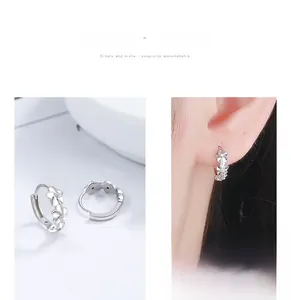 Close-up of S925 sterling silver camellia hoop earrings on model and background