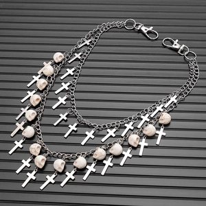 Close-up of double-layered punk pants chain with silver crosses and skull beads detail