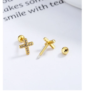 Detailed macro view of a gold cross stud earring with sparkling zircons and a screw back