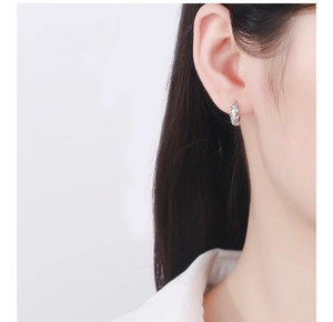 Close-up of 925 sterling silver hoop earrings with delicate camellia flower patterns