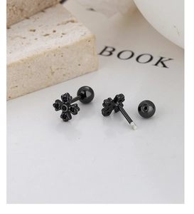 Vue macro de boucles d'oreilles croix noires avec zircons et fermoir à vis