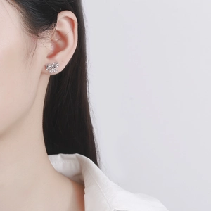 Elegant hollow lace bow stud earrings in 925 sterling silver worn by a model