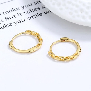 Macro shot of 925 sterling silver gold earrings with chain design and S925 hallmark