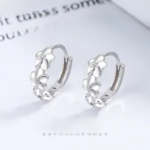 Detailed view of sterling silver flower hoop earrings with sparkling zircon accents