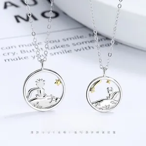 Macro detail of S925 sterling silver Le Petit Prince and Fox couple necklaces
