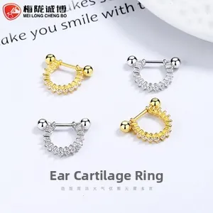 Macro detail of 925 sterling silver cartilage hoops set with shimmering cubic zirconia