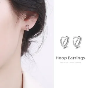 Detail view of hollow intertwined silver hoop earrings shown on model and white background