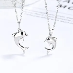 Detailed view of polished S925 sterling silver dolphin pendants with micro-pave zircon stones