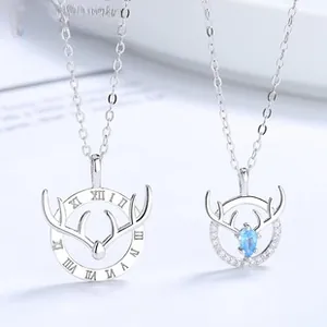 Detail of s925 silver couple necklaces featuring elk horn pendants and blue gemstone