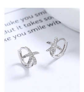 Macro view of starfish huggie earrings in 925 sterling silver with micro-pave zircons
