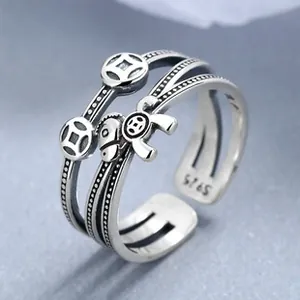 Macro detail of S925 sterling silver ring showing coin charms and S925 hallmark