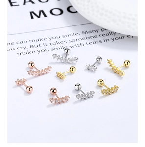 Detailed close-up of curved bar screw-back cartilage earrings with sparkling cubic zirconia