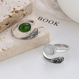 Macro detail of S925 sterling silver rings with feathers and oval gemstone insets