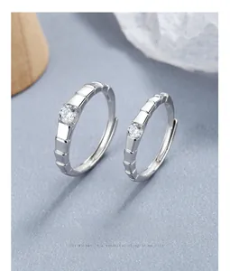 Macro detail of silver 925 couple rings with grooved texture and center zircon stones