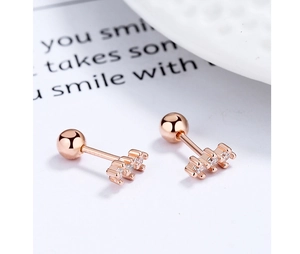 Detail of rose gold curved bar earrings with triple row zircon and ball back screw