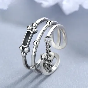Detail of vintage 925 silver layered ring with beads and black rectangular charm