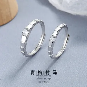 Detailed view of 925 sterling silver Mobius couple rings with sparkling cubic zirconia