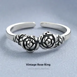Detailed view of vintage 925 silver rings featuring intricate rose flower carvings
