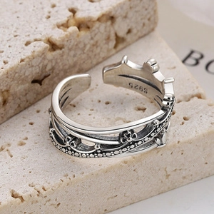 Macro shot of vintage S925 sterling silver crown ring showing hollow wave and floral detail