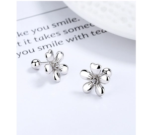 Macro shot of 925 silver flower stud earrings with zircon and secure screw-back closure