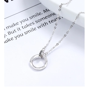 Detail of Moebius S925 silver pendant with black zircon inlay and engraved text