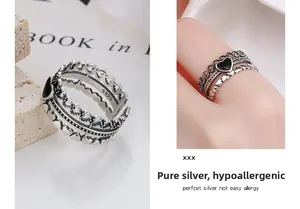 Detailed view of vintage S925 sterling silver triple layer ring with black heart design