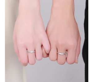 Macro detail of 925 silver couple rings with square stone on hands in a close-up pose