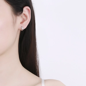 Starfish hoop earrings in 925 sterling silver with sparkling pave zircon on female model