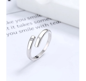 Close-up of S925 sterling silver hallmark and sparkling zircon on minimalist open ring