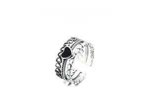 Detailed view of vintage S925 sterling silver triple-layer ring with black heart element
