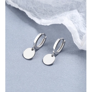 Close-up of polished S925 sterling silver hoop earrings with round geometric charms