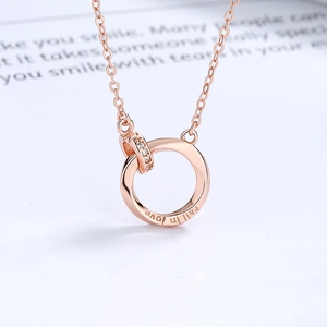 Rose gold Mobius necklace with interlocking rings and Fall in Love engraving