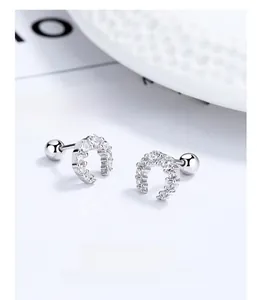Macro shot of 925 silver moon stud earrings with zircons and screw ball backings