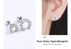 Detailed view of silver crescent moon screw back earrings with sparkling zircon stones