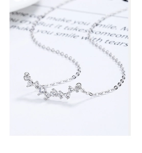 Macro detail of 925 sterling silver smile necklace with sparkling zircon pave stones