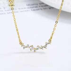 Close-up of a gold smile pendant necklace featuring shimmering cubic zirconia stones