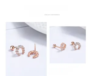 Macro detail of rose gold U-shaped screw back earrings with sparkling cubic zirconia pavé