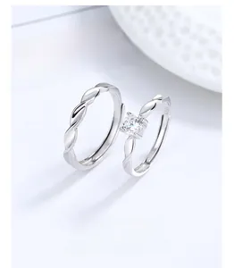 Detail of S925 sterling silver Mobius rings with a square zircon on a white background