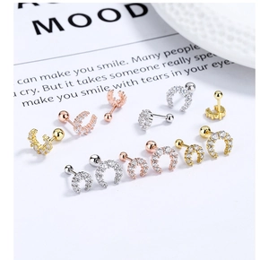 Macro view of crystal crescent moon stud earrings with screw back in gold and silver