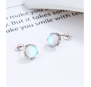 Macro shot of S925 sterling silver studs with glowing aurora moonstone and S925 hallmark