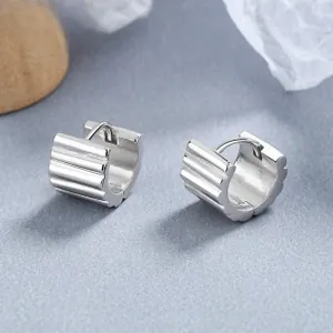 Close-up of polished 925 sterling silver drop earrings with modern vertical grooved texture