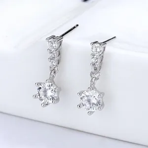 Close-up of 925 silver star tassel earrings with round cubic zirconia in six-prong setting
