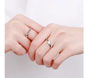 Close-up of Möbius couple rings in 925 sterling silver with a sparkling zircon stone inlay