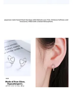 Detailed close-up of hollow heart silver earrings with delicate beaded edge lace texture