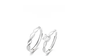 Macro detail of S925 sterling silver stamp on Mobius couple rings with zircon stones