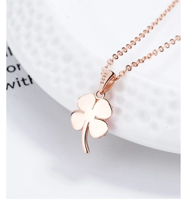 Macro detail of rose gold clover pendant with clear S925 sterling silver hallmark