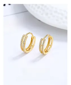 Detailed macro of gold double-layer S925 sterling silver hoop earrings with pavé stones