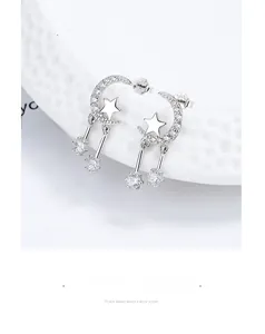 Macro shot of S925 sterling silver star and moon earrings with cubic zirconia tassels