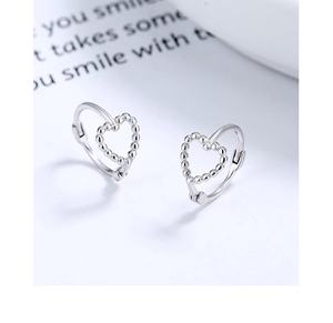 Detailed view of sterling silver hollow heart hoop earrings with beaded texture